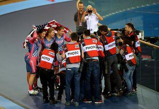 Photographers crowd round the USA team after the win the Women's Team Pursuit final during Day Three of the UCI Track Cycling World Championships