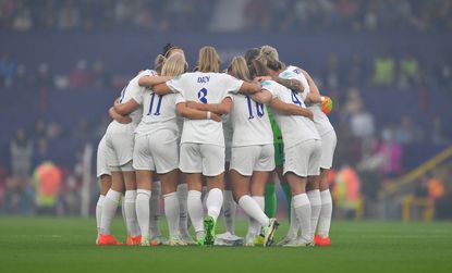 MANCHESTER, ENGLAND - JULY 06: The England team have a group huddle before the kick off of the UEFA Women's Euro England 2022 group A match between England and Austria at Old Trafford on July 6, 2022 in Manchester, United Kingdom. (Photo by Dave Howarth - CameraSport via Getty Images)