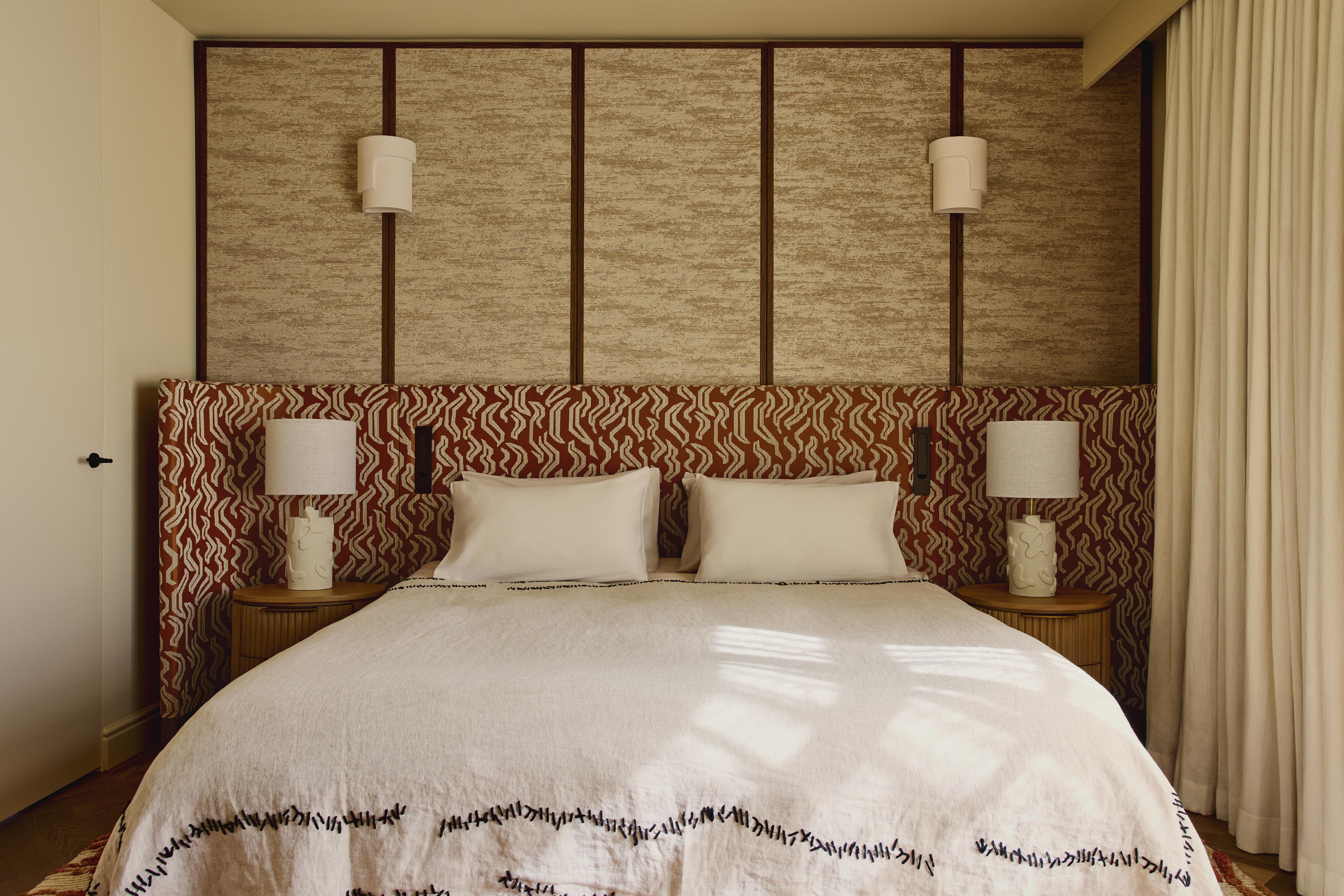 Bedroom featuring upholstered headboard and panelled walls