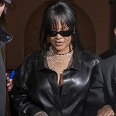 Rihanna was spotted in Paris with A$AP Rocky wearing a leather button-down and asymmetrical skirt from Givenchy
