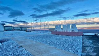 a photo of the ALMA facilities blanketed in snow, with the "ALMA" sign visible