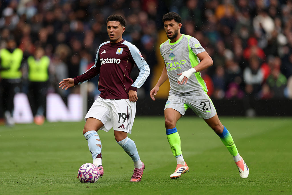 BIRMINGHAM, ENGLAND - OCTOBER 26: Jadon Sancho of Aston Villa passes the ball whilst under pressure from Matheus Nunes of Manchester City during the Premier League match between Aston Villa and Manchester City at Villa Park on October 26, 2025 in Birmingham, England. (Photo by Dan Mullan/Getty Images)