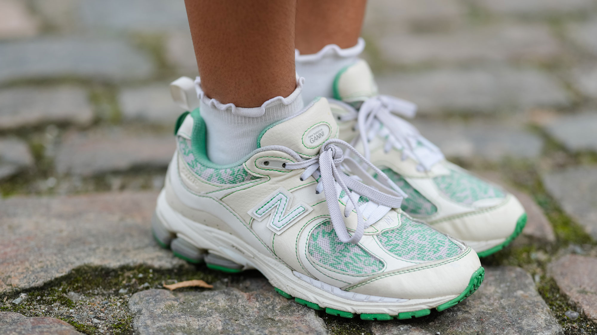 a woman wears ruffled socks with New Balance sneakers