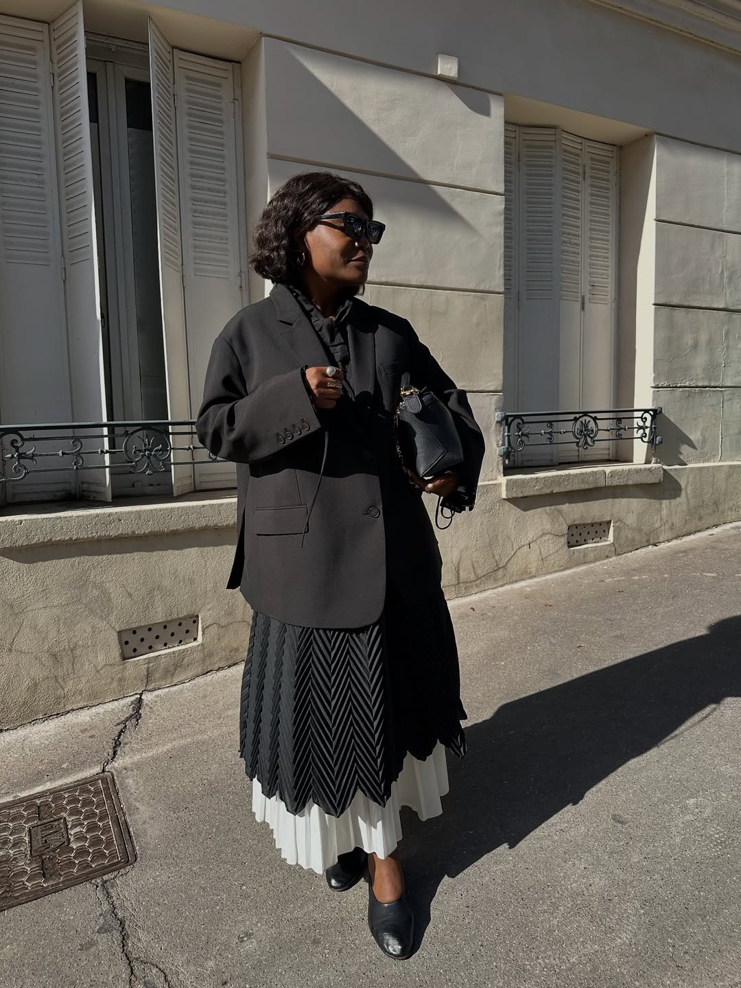 Influencer Frann Fyne wearing layered skirts and blazer.