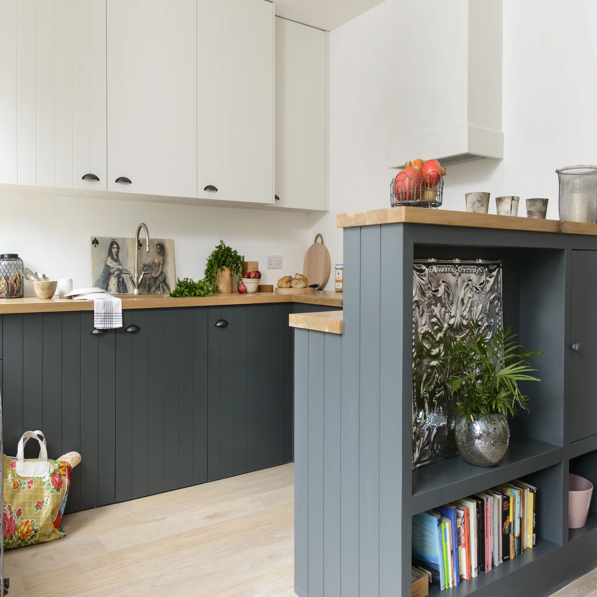 gray base cabinets with white upper cabinets and parquet