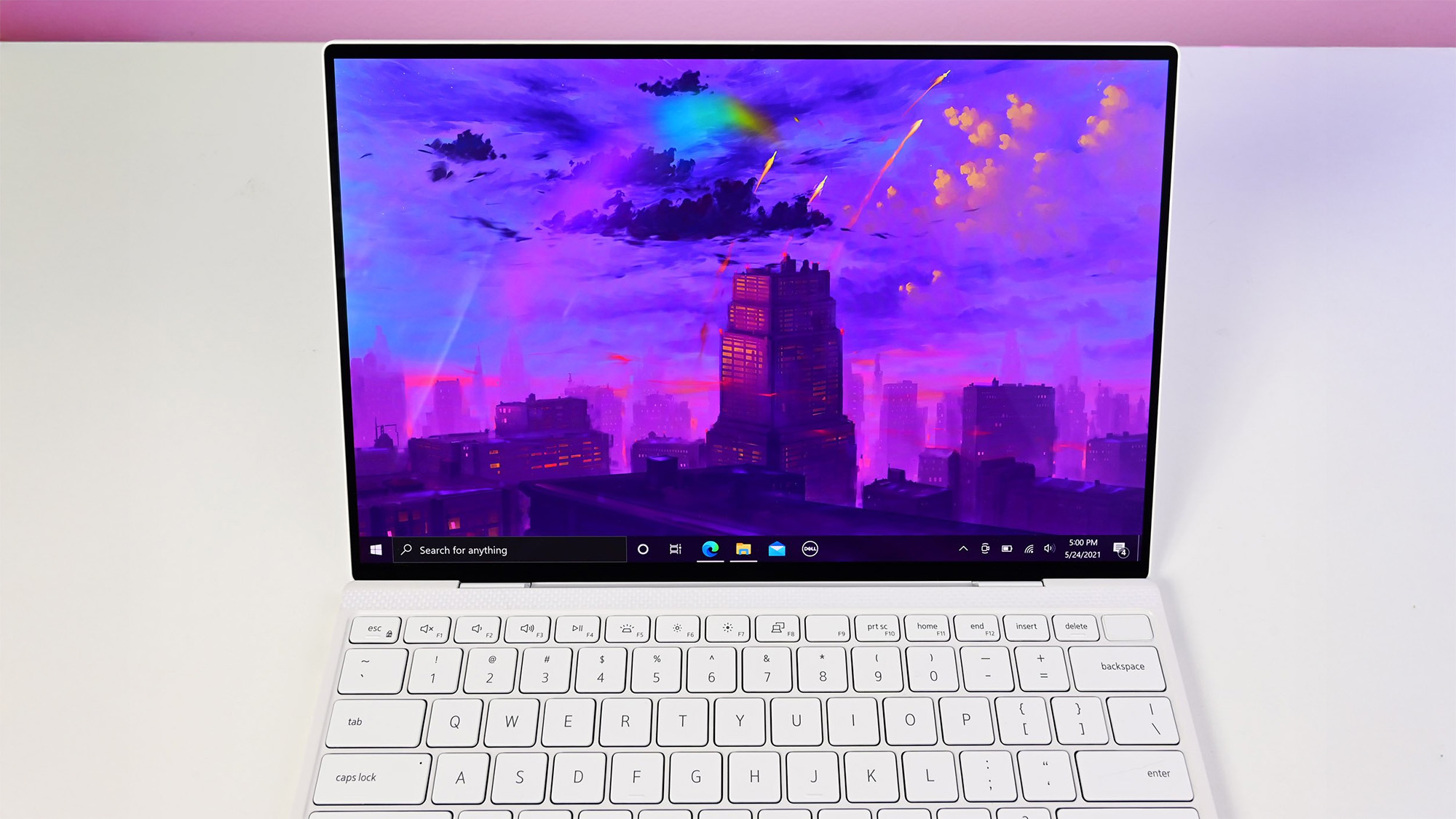 Dell XPS 13 9310 on a white table, showing Windows 10 desktop