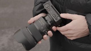 Sigma 50mm F1.2 DG DN Art lens in the hand