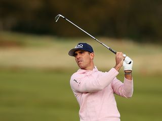 Billy Horschel watching the flight of his golf ball after hitting an iron shot