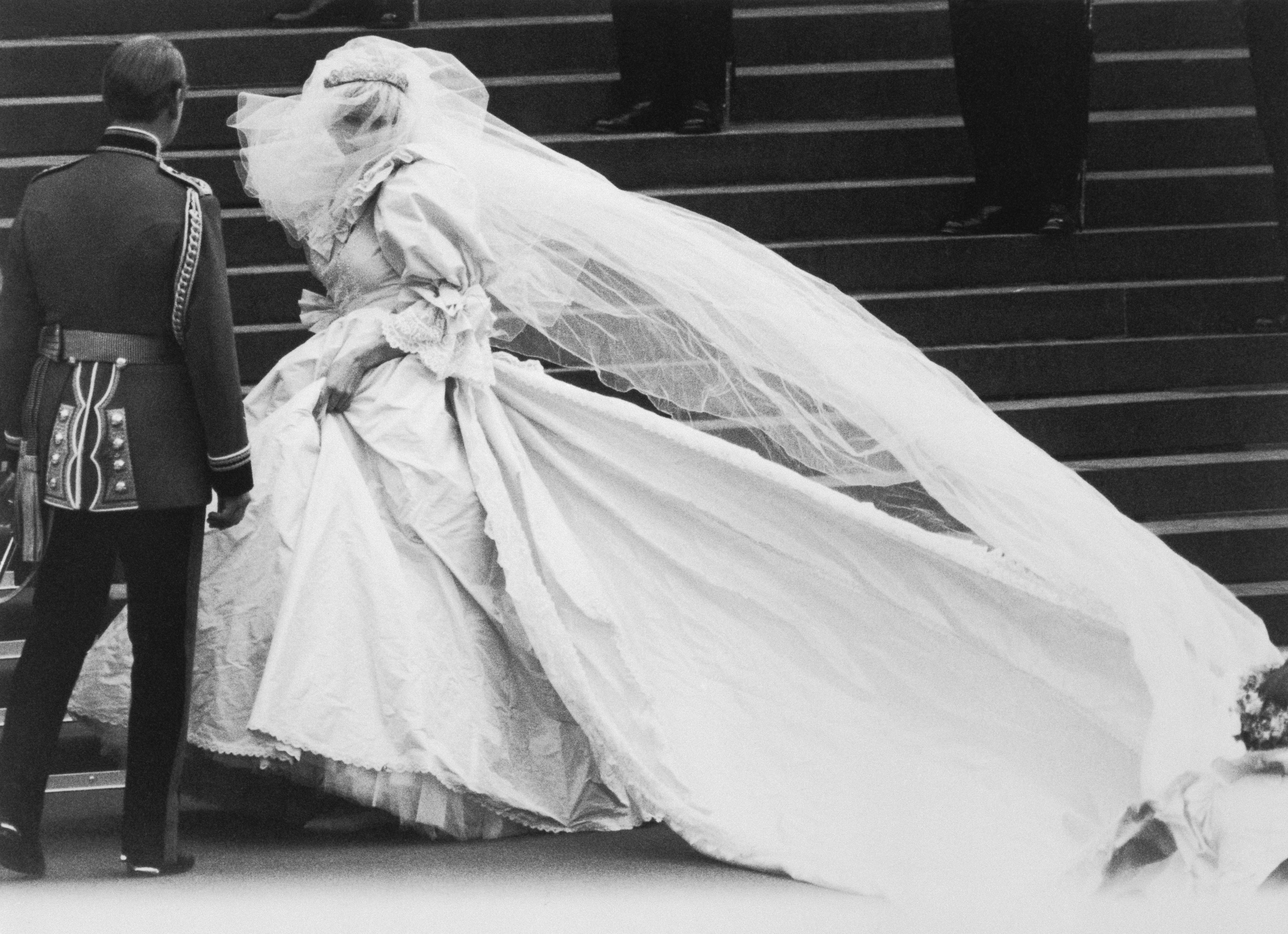 Princess Diana wearing her wedding gown with her veil covering her face