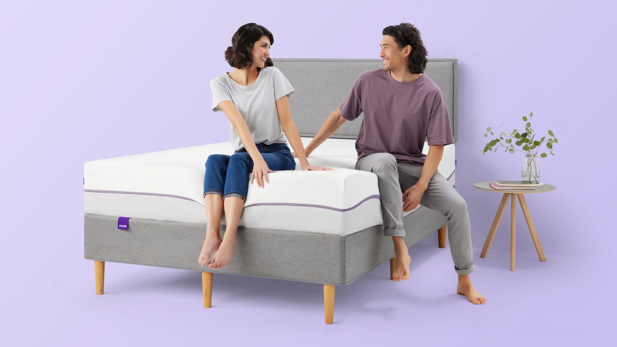 Purple launches new Purple Plus mattress with deluxe cushioning for comfier sleep: A smiling couple sit on the Purple Plus mattress