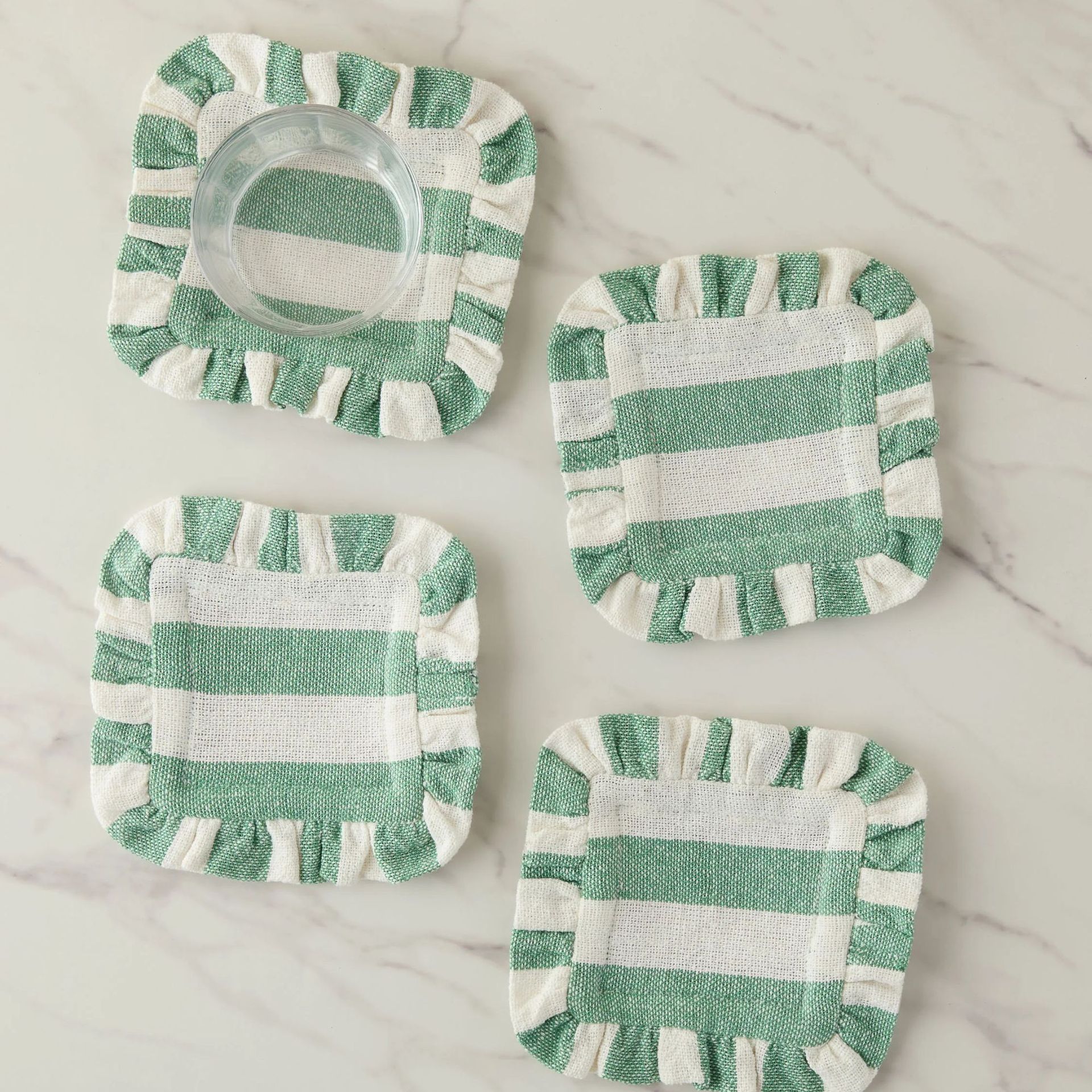 Sunday Striped Table Linens against a marble surface.