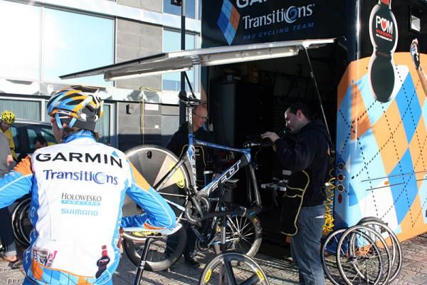 Johan Van Summeren looks on as the team's mechanics work on the bikes.