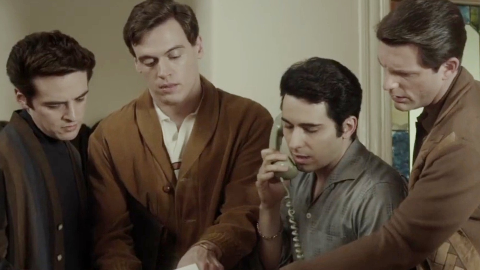 The boys huddled around a telephone in Jersey Boys