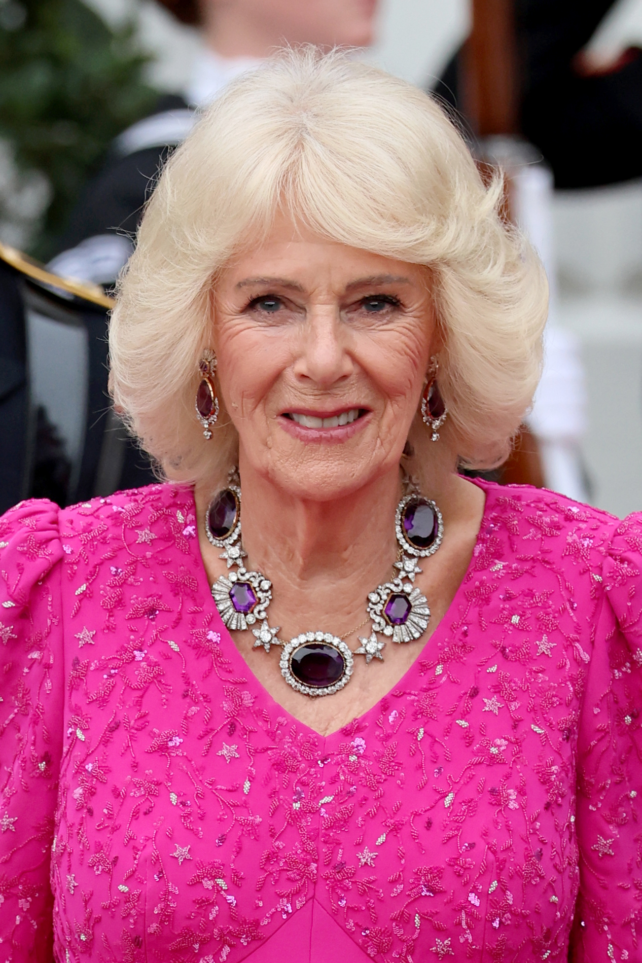 Queen Camilla wearing a pink gown and amethyst necklace