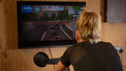 Female cyclist riding on Zwift which is one of the best indoor training platforms