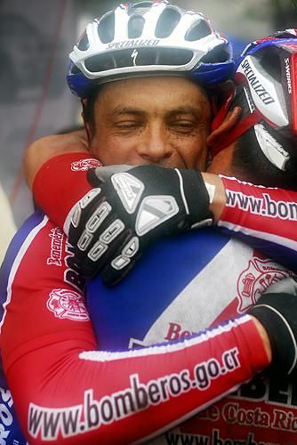Two teammates embrace after stage four.