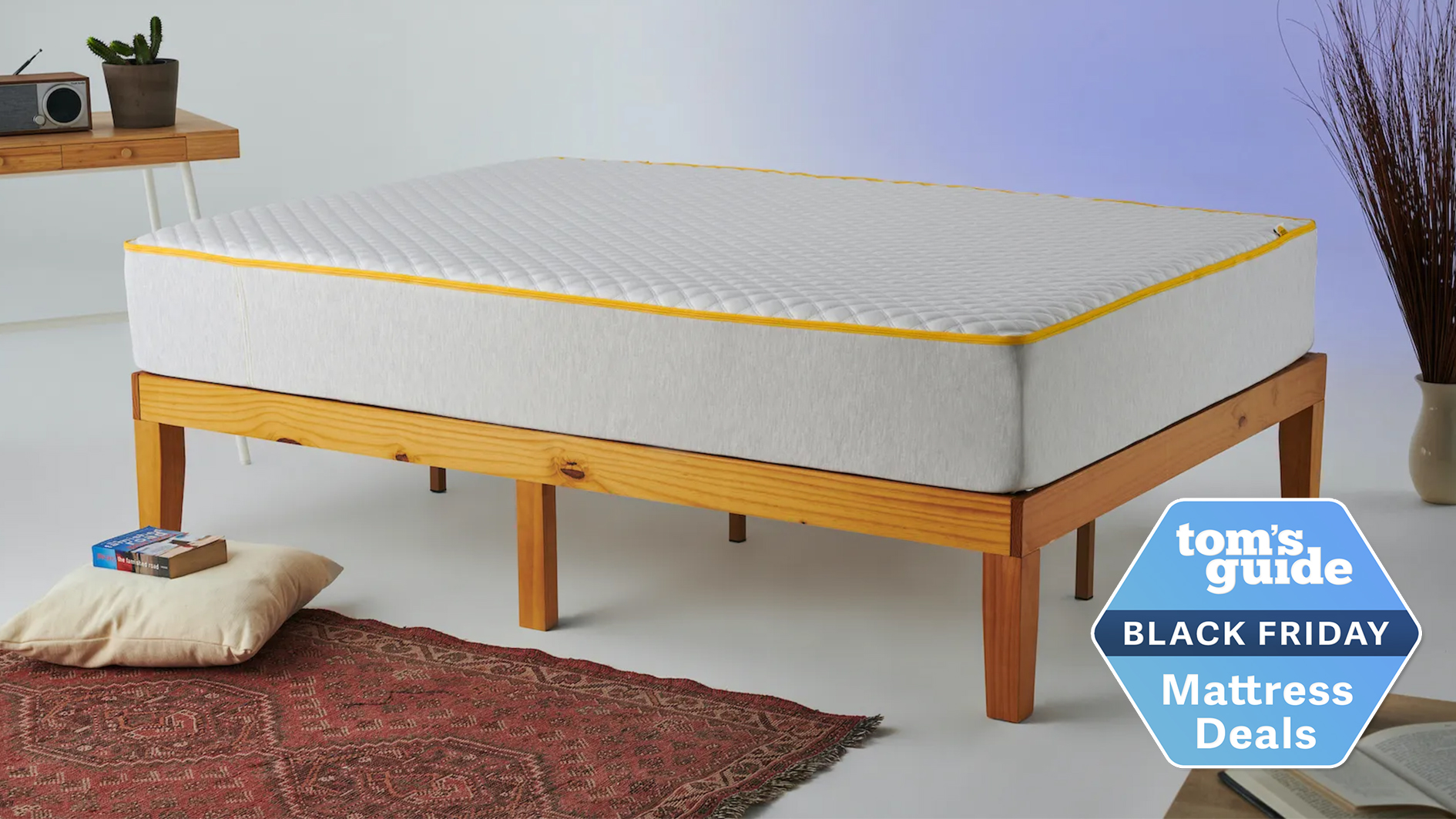 The Eve Premium Hybrid mattress shown on a light wooden bed frame with a blue Tom&#039;s Guide Black Friday mattress deals badge overlaid in the bottom right hand corner
