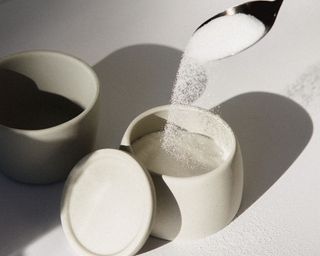a spoon of sugar from a sugar bowl
