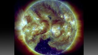A dark coronal hole at the bottom of the sun