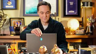 Jim Parsons as Sheldon Cooper looking at a laptop screen in the Young Sheldon finale.