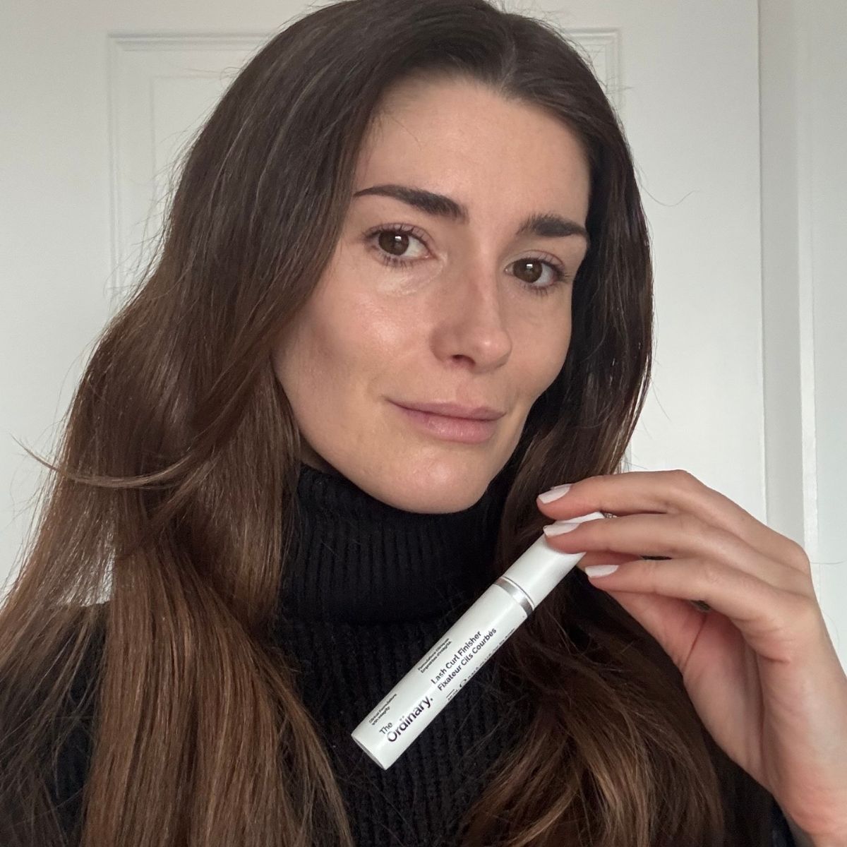 beauty editor Eleanor Vousden holding The Ordinary Lash Curl Finisher