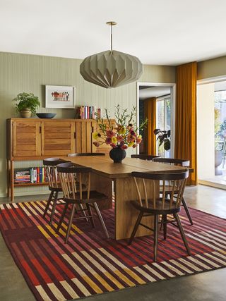 dining room with striped rug and striped storage