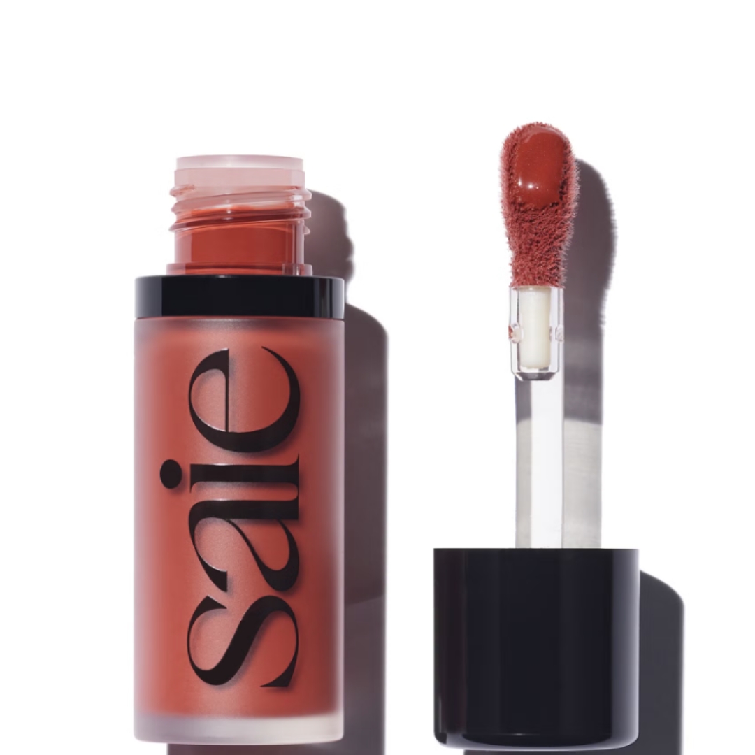 A product shot of the Saie Dew Blush Liquid Cheek Flush, on a white background