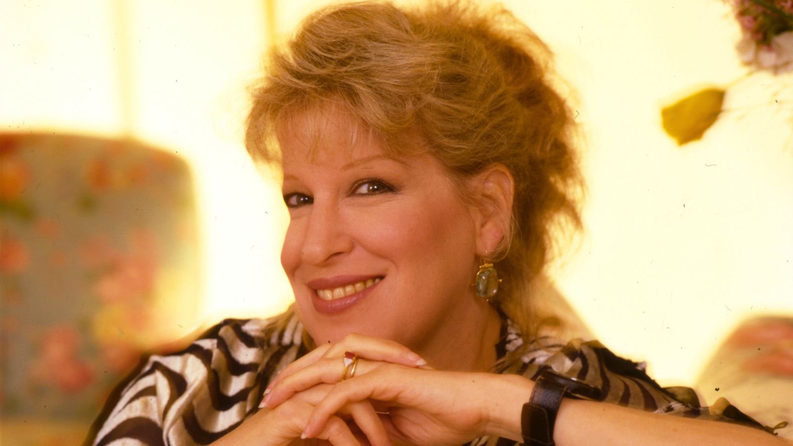 bette midler on a yellow background