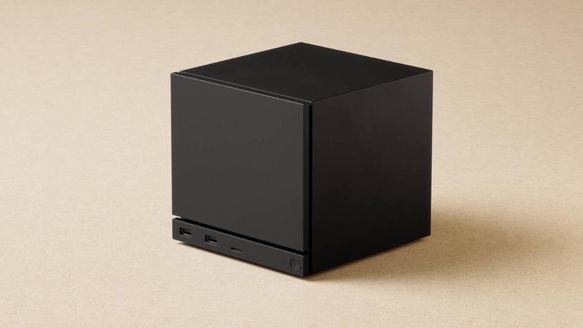 Black Steam Machine PC with beige backdrop.