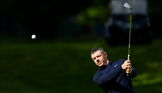 Rory McIlroy hits a wedge from the bunker shot