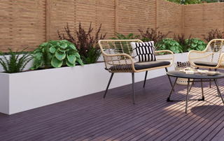 Decking with planter behind and table and chairs to left hand side