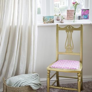 room with chair and white curtain