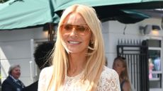 Tess Daley pictured at Wimbledon with sunglasses on and a white lacy dress