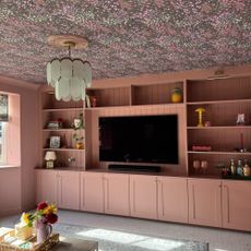 living room with wallpapered ceiling and built in joinery