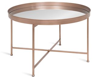 A round coffee table in rose gold finish