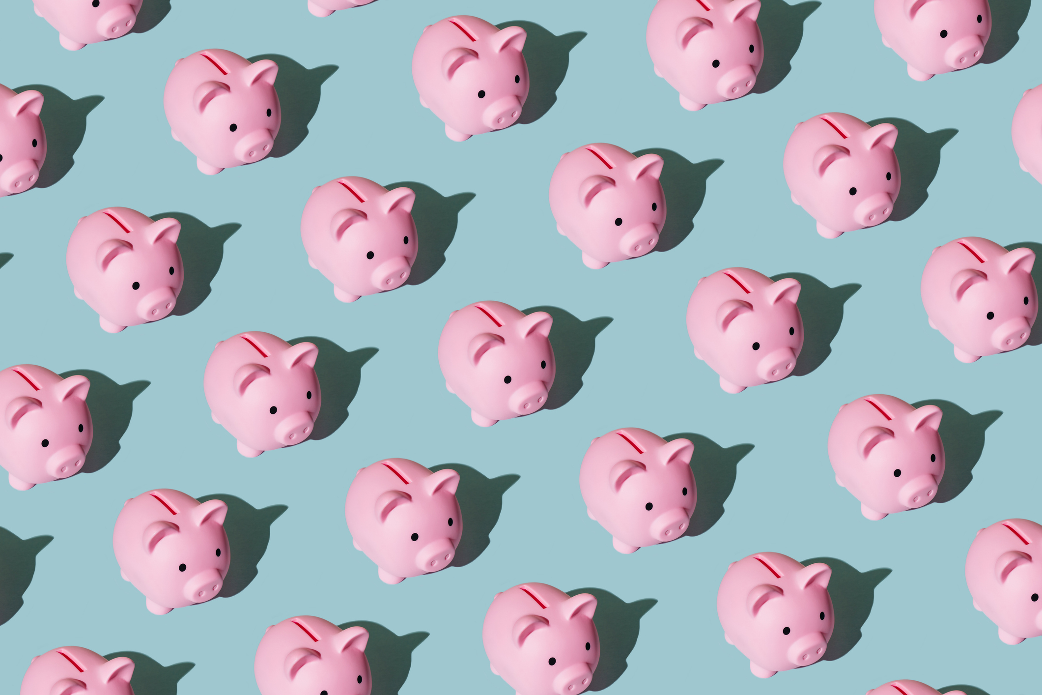Pink piggy banks against blue background