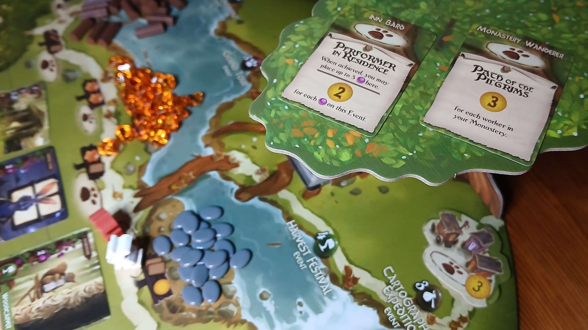 Everdell components, board, and cards laid out on a wooden surface