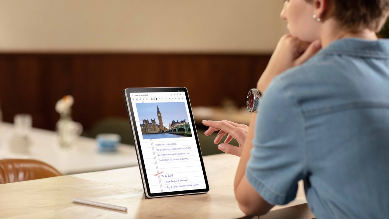 Woman using Samsung Galaxy tablet on a desk 