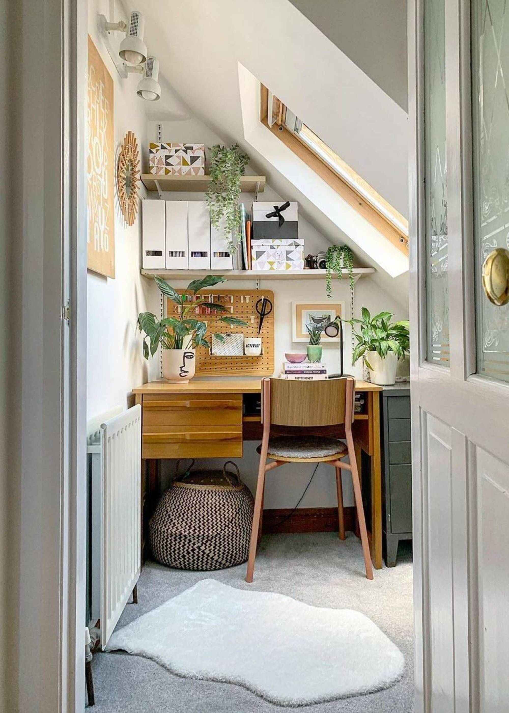 white office room in the loft with sloping eaves and roof light