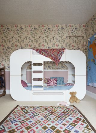 A bedroom with a white bunk bed