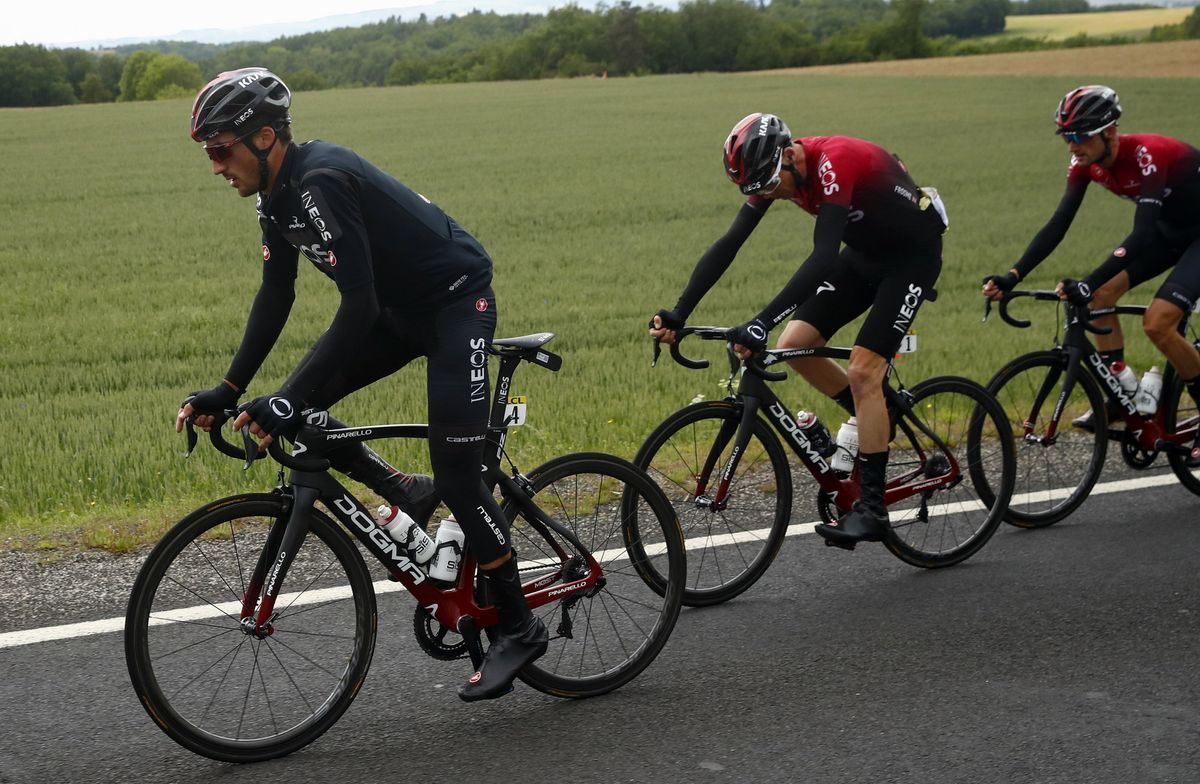 Chris Froome takea a look at his bike