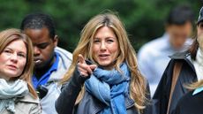 Jennifer Aniston wearing jeans and a denim scarf