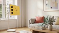 The StanbyME 2 Max sits on the side of a living room displaying a yellow clock face