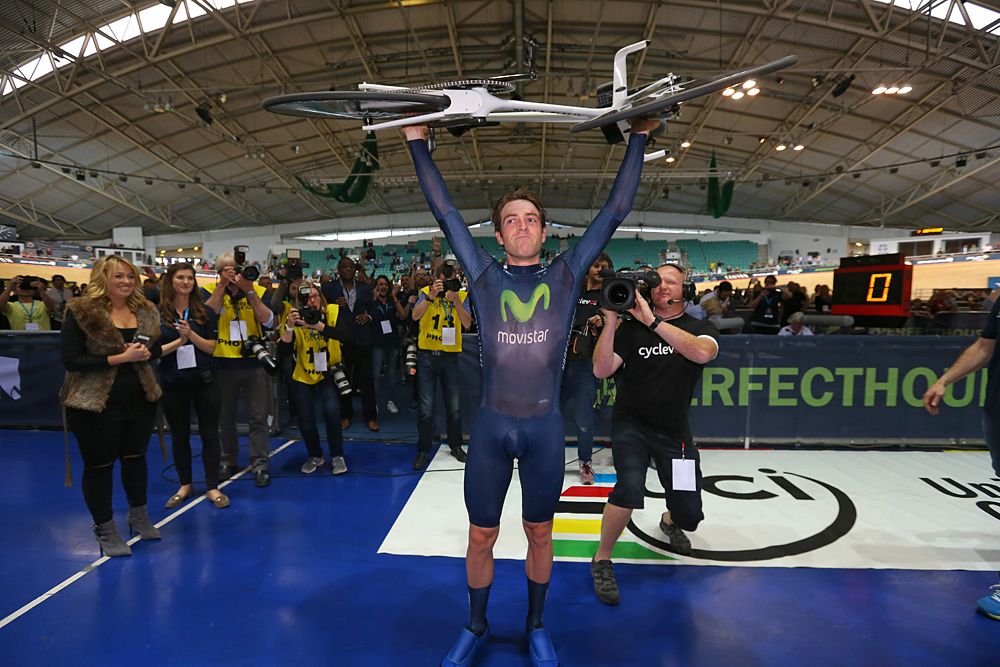 Alex Dowsett (Movistar) lifts his bike in the air in celebration of beating the Hour Record