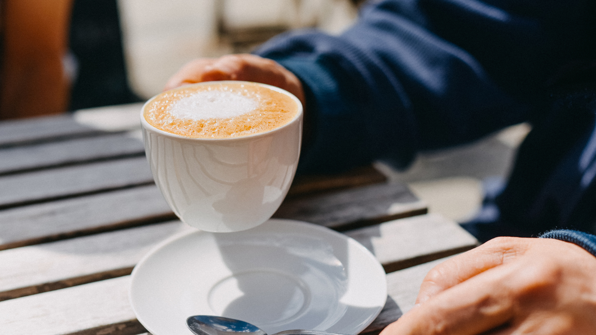 man drinking a soy milk cappuccino