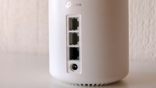 A close-up shot of the rear Ethernet ports of a TP-Link Deco XE75 Pro