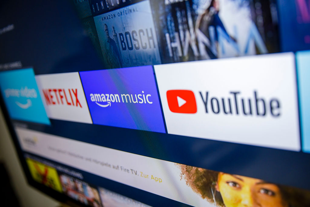 The logos of the streaming services Amazon Prime Video, Netflix, amazon music and youtube can be seen on a television (Photo by Thomas Trutschel/Photothek via Getty Images)