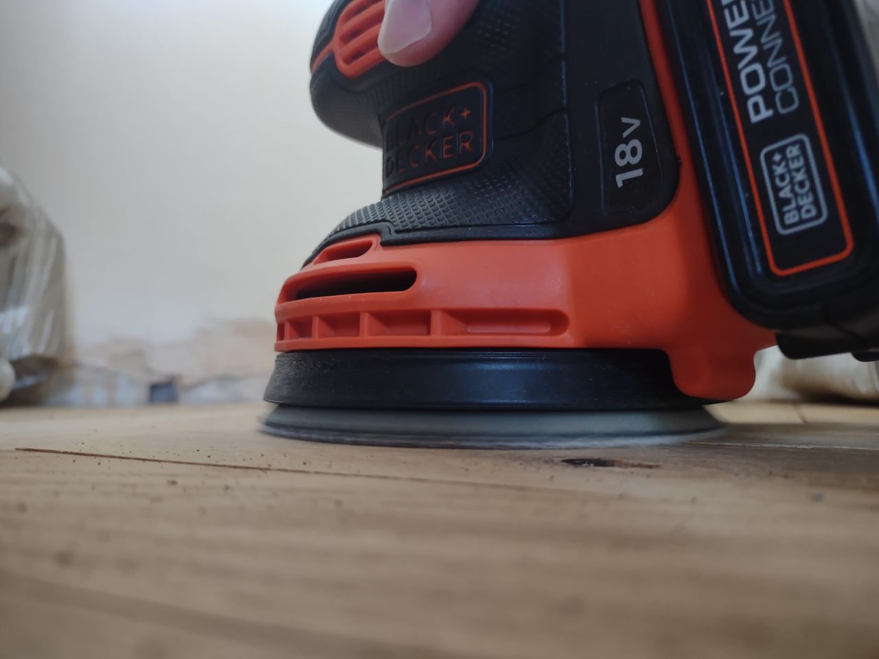 The Black and Decker BDCROS18 18v Cordless Disc Sander in use