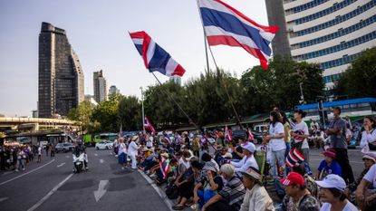 Protesters seen in Bangkok urging Thailand's prime minister to resign. 