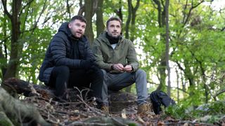 Aaron and John sitting in the woods side by side